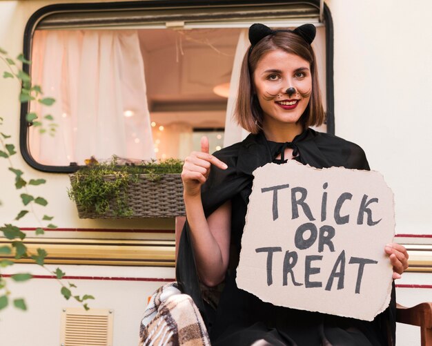 Smiley woman holding halloween sign