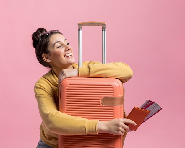 Smiley woman holding her baggage