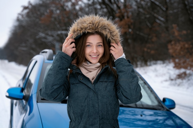 Free photo smiley woman holding jacket medium shot