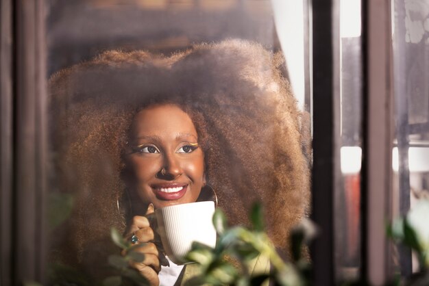 Smiley woman holding mug front view