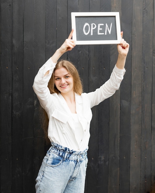 Free Photo smiley woman holding open sign