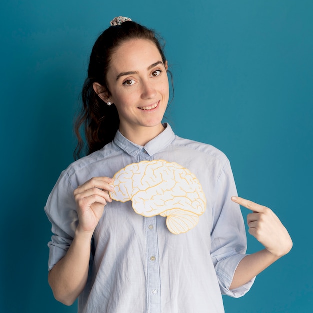 Free Photo smiley woman holding paper brain