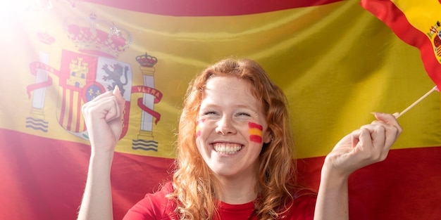 Smiley woman holding the spanish flag