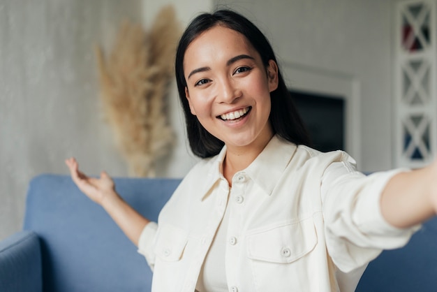 Free photo smiley woman live streaming with her phone