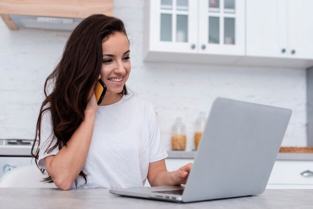 Smiley woman looking on her laptop