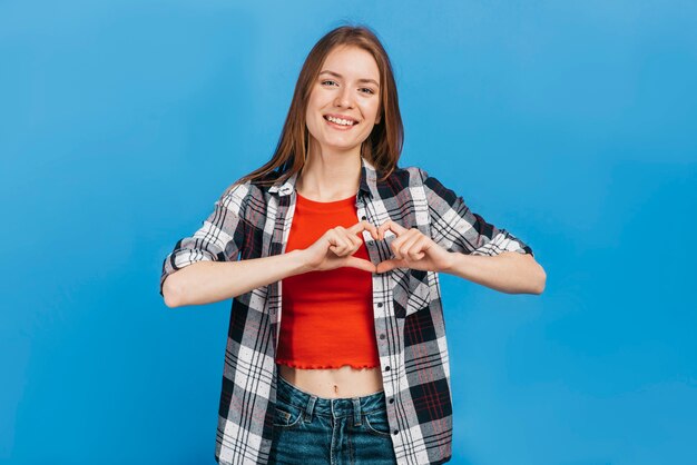 Smiley woman making a heart with her hands