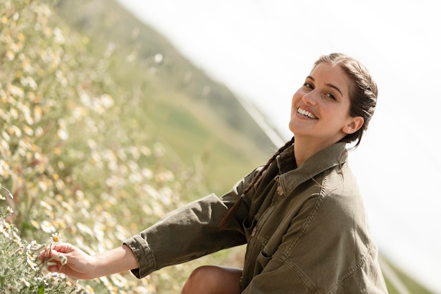 Smiley woman outdoors medium shot