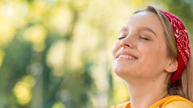 Smiley woman outdoors with copy space