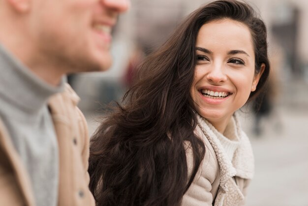 Smiley woman outdoors with man