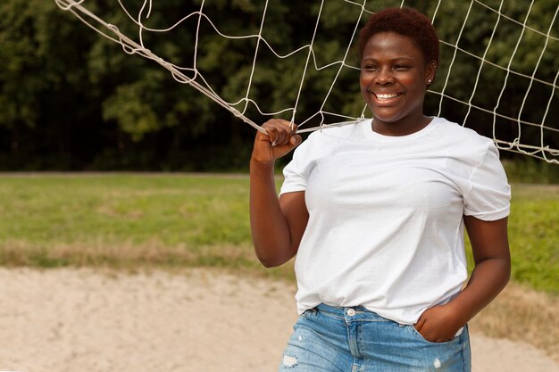 Smiley woman outdoors with net