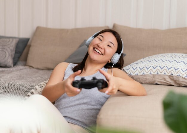 Smiley woman playing videogame