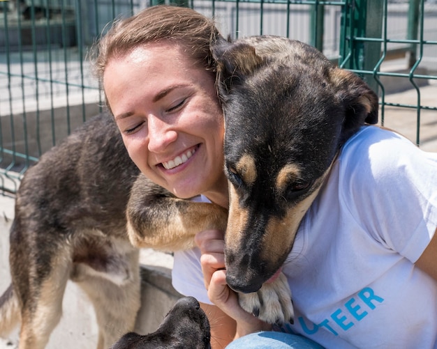 Smiley woman playing with cute dog up for adoption