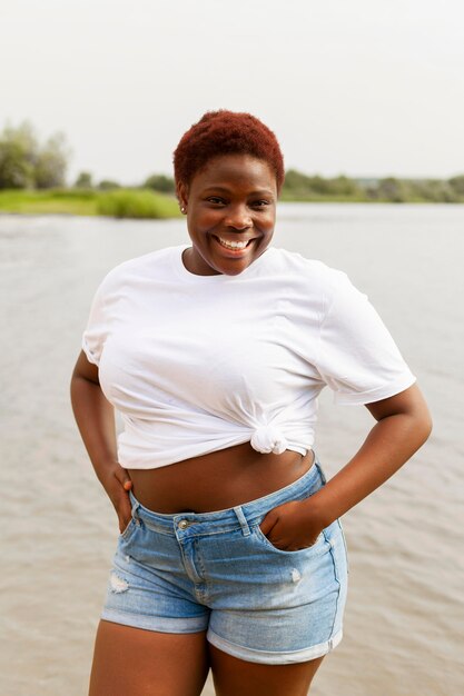 Smiley woman posing at the beach