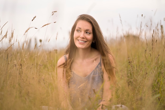 Free photo smiley woman posing in nature medium shot