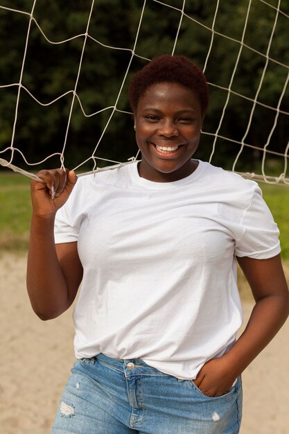 Smiley woman posing outdoors with net