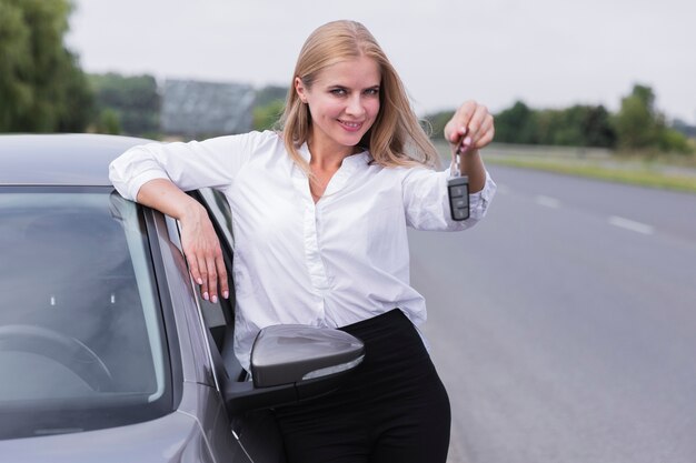 Smiley woman posing with car keys  