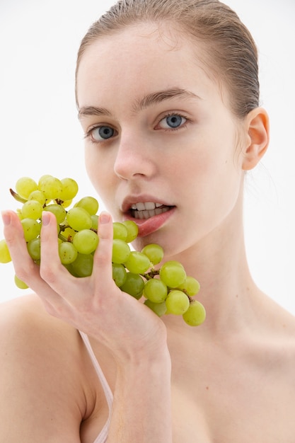 Smiley woman posing with grapes