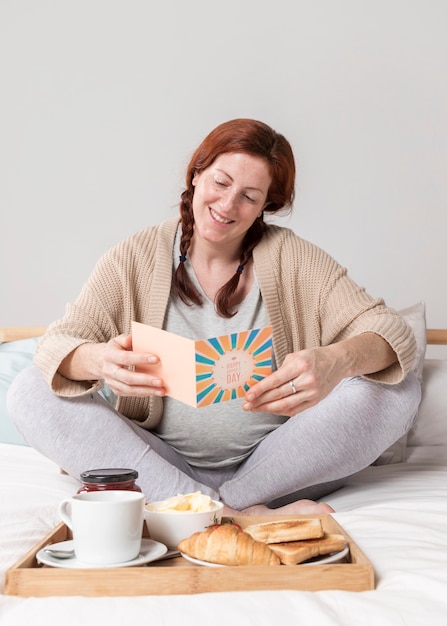 Free Photo smiley woman reading greeting card