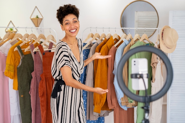 Free Photo smiley woman selling clothes side view