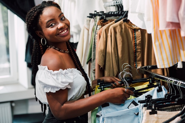 Smiley woman at shopping in clothing store