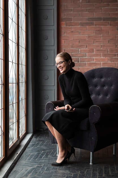 Smiley woman sitting on couch