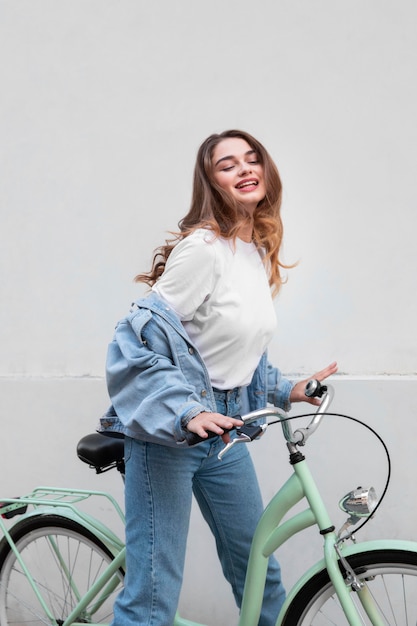 Smiley woman sitting on her bike