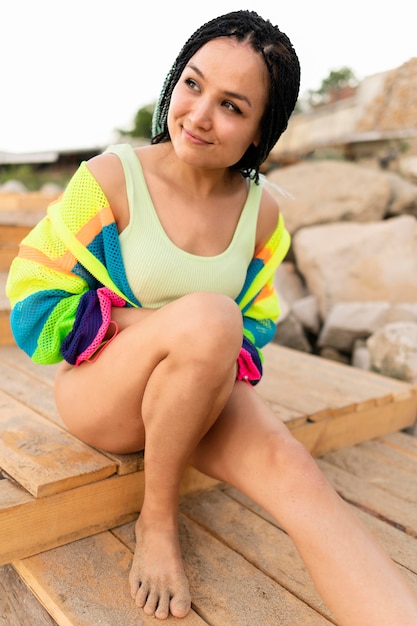 Free Photo smiley woman sitting outdoors