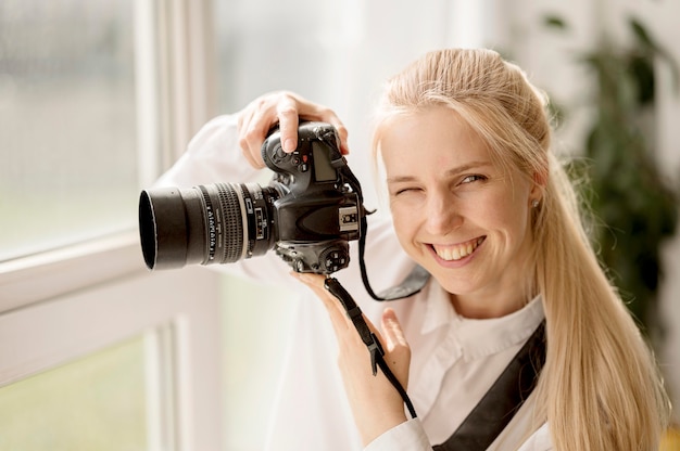 Smiley woman taking a photo