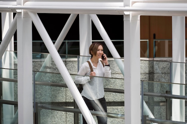 Free photo smiley woman talking on phone medium shot