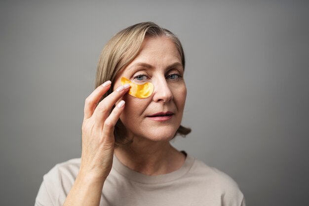 Smiley woman using eye patch