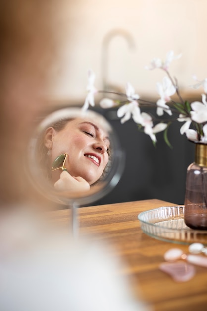 Smiley woman using gua sha tool