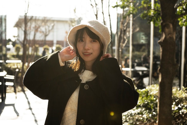 Smiley woman wearing bucket hat medium shot