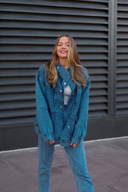 Free photo smiley woman wearing total denim outfits front view