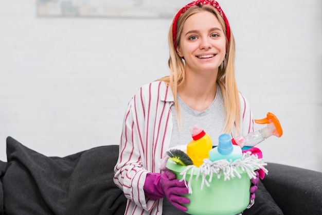 Free photo smiley woman with cleaning products