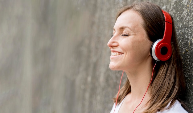 Free Photo smiley woman with headphones