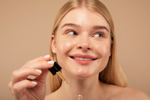 Free Photo smiley woman with serum close up