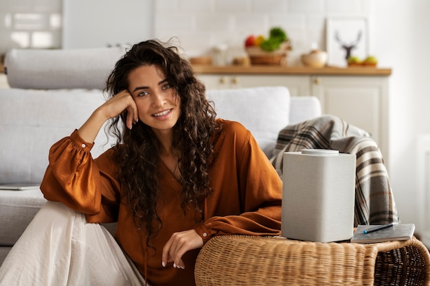 Smiley woman with smart speaker front view