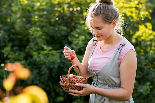 Smiley woman with strawberries basket