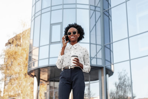 Smiley woman with sunglasses talking over phone