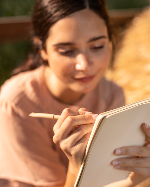 Smiley woman writing close up