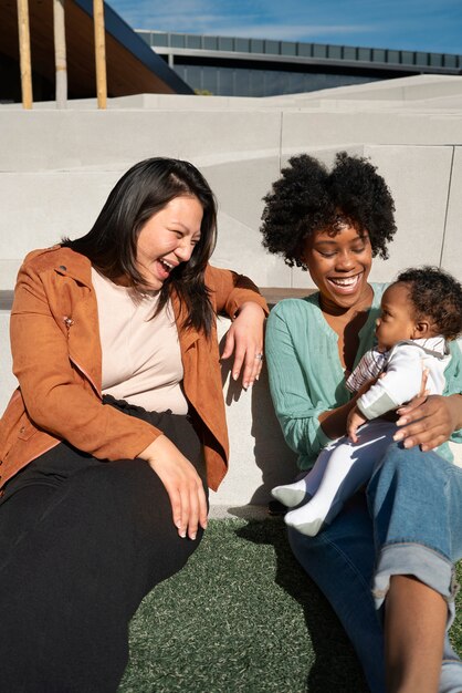 Smiley women and cute baby outdoors