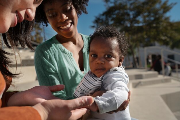 Smiley women and cute baby outdoors