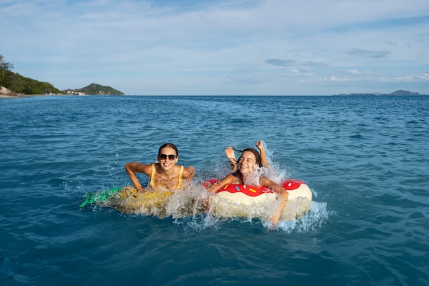 Smiley women on floaters high angle