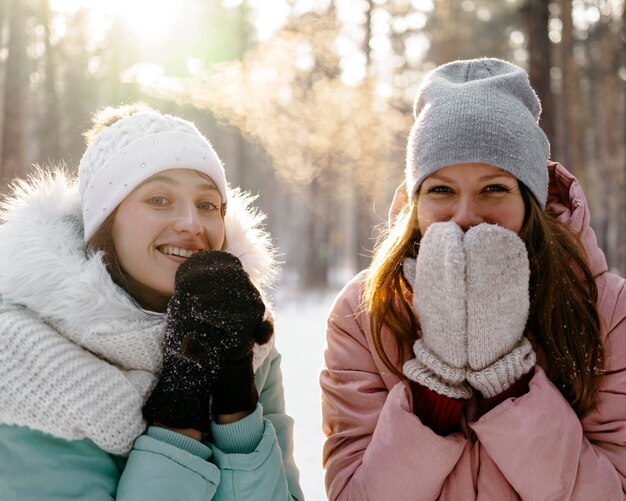 Smiley women together outdoors in winter