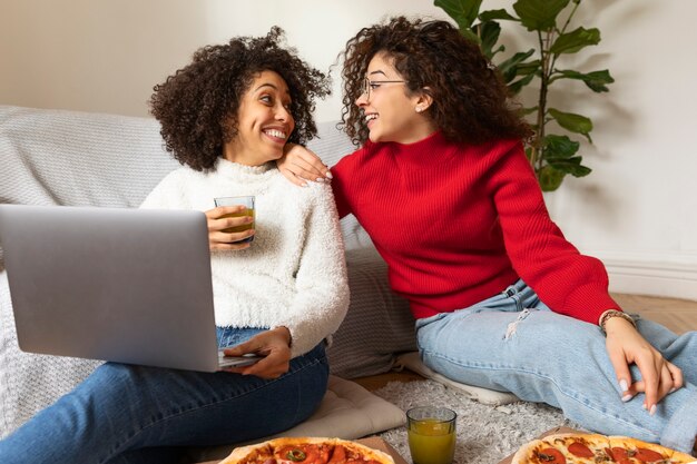 Smiley women with laptop medium shot