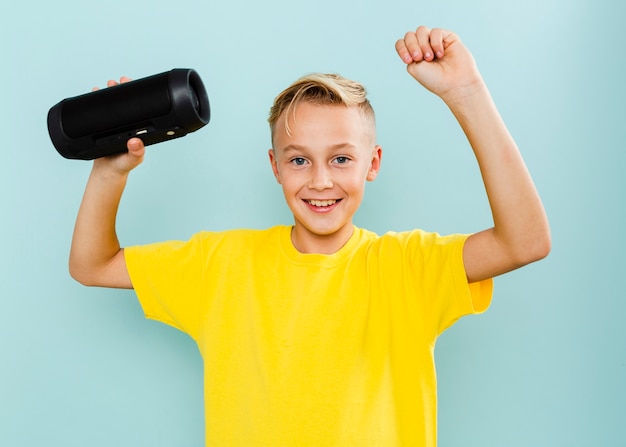 Smiley young boy holding cassette