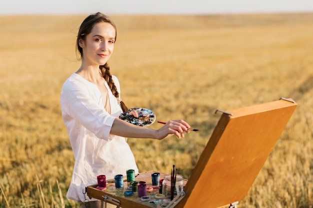 Free Photo smiley young woman hand painting