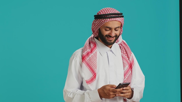 Smiling adult typing messages on phone