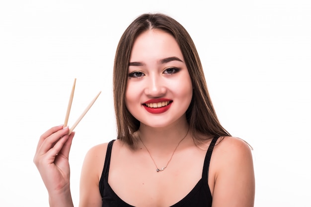 Smiling asian hold wooden chopsticks in her hands