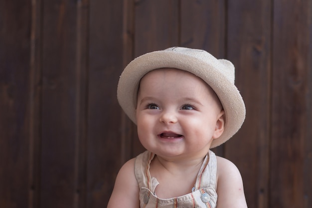 Smiling baby in summer hat.